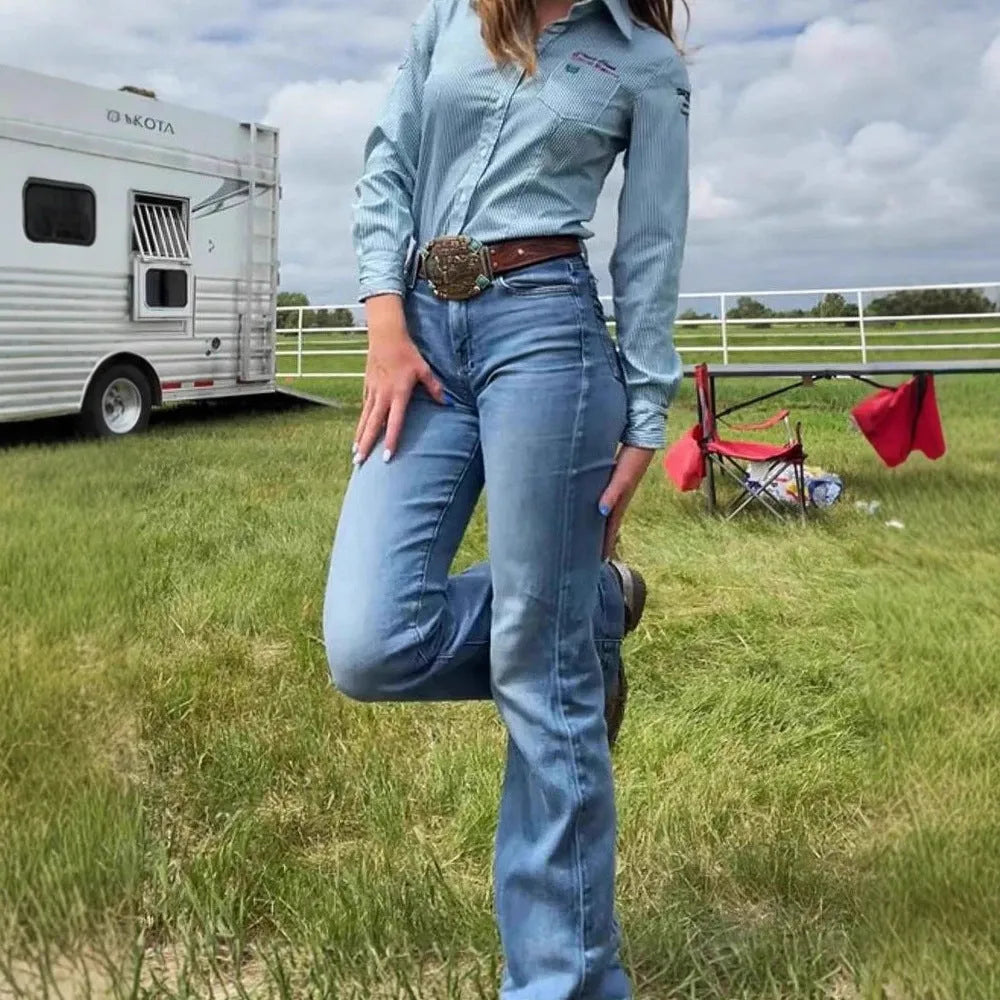 Women's slim fit blue embroidered jeans with a slight flare and mid-rise waist.