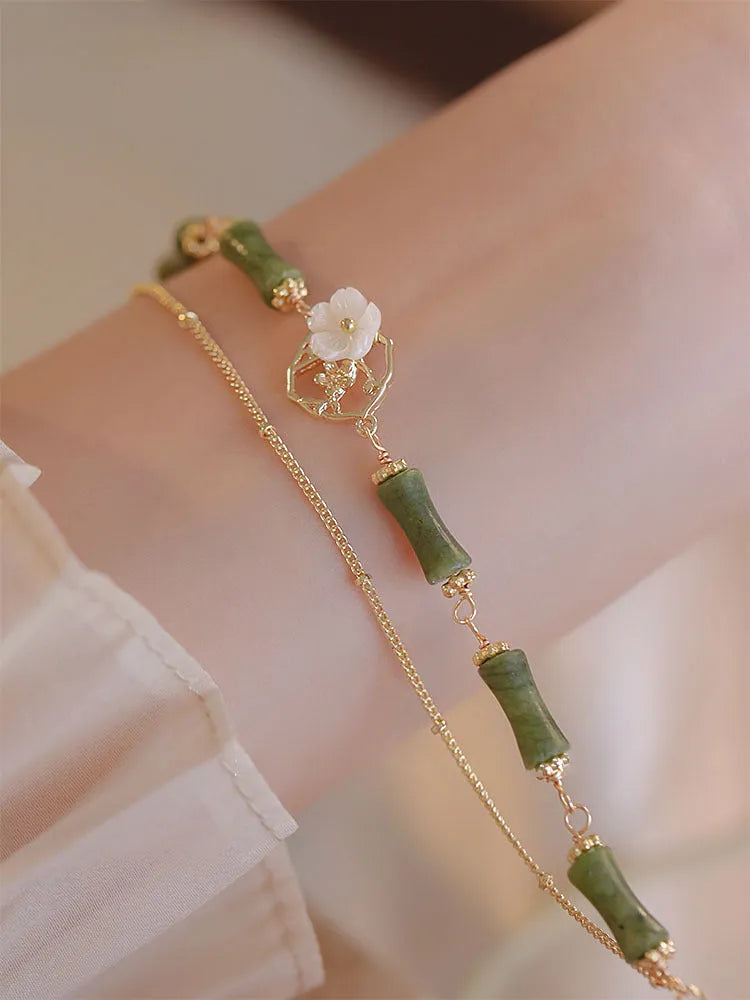 Handmade olivine bracelet with double layer Twin Bells of Ireland design on adjustable string cord