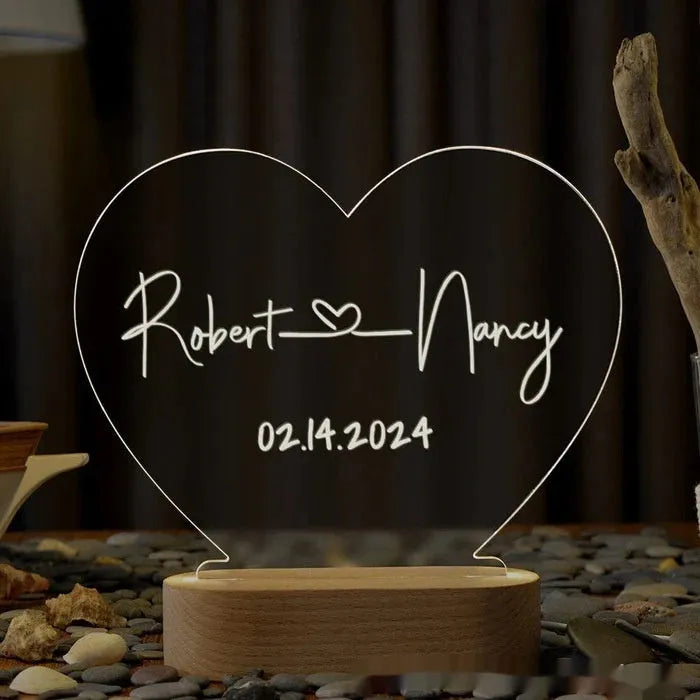 Custom acrylic LED night light with engraved names and date for Valentine's Day.