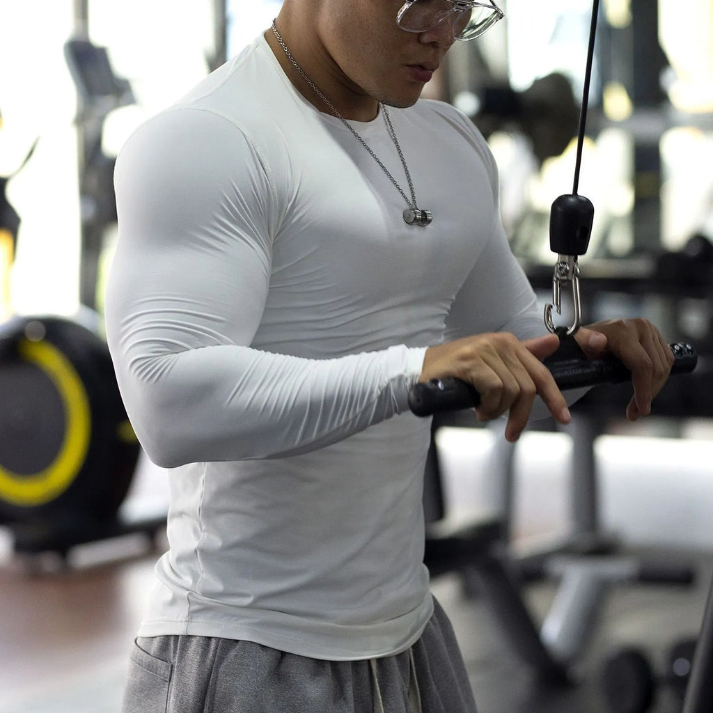 Man wearing black long-sleeved slim-fit fitness tights for running or gym workout