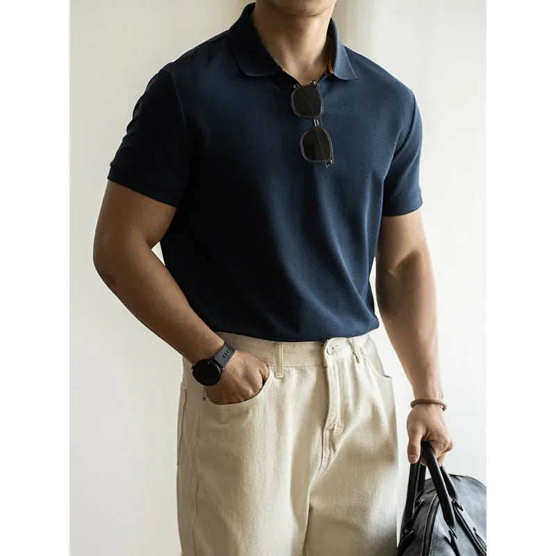 Blue short-sleeved polo shirt on a hanger, showing regular fit and cotton-polyester fabric blend.