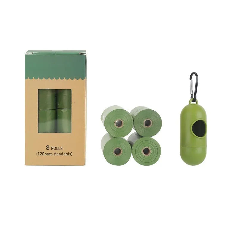 A roll of green EPI degradable pet waste bags next to a black dispenser on a grass background.