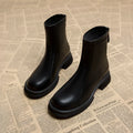 Women's black flat heel ankle boots with back zipper and round toe design