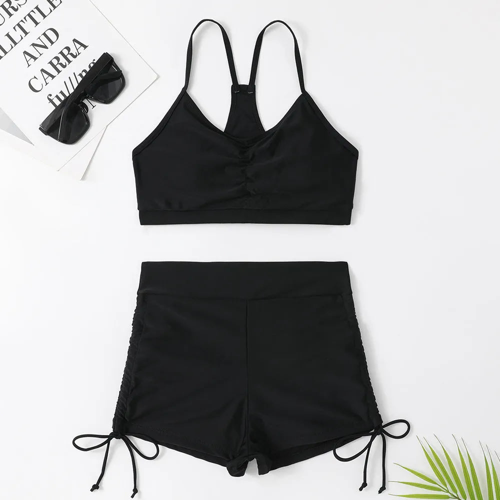 Purple and black women's high-waisted split bikini swimsuit on a mannequin.