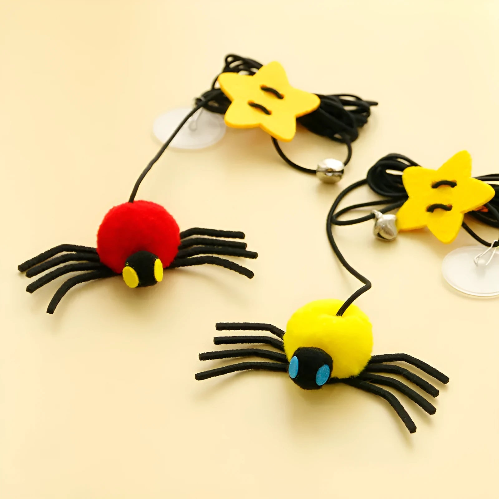 Red or yellow cat toy hanging from door with elastic rope, feathers, bells and spider attachment