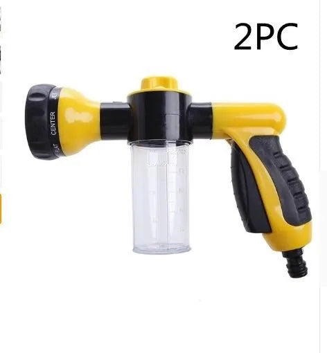 Green high-pressure foam spray gun for car washing with adjustable nozzle and attached water pipe.