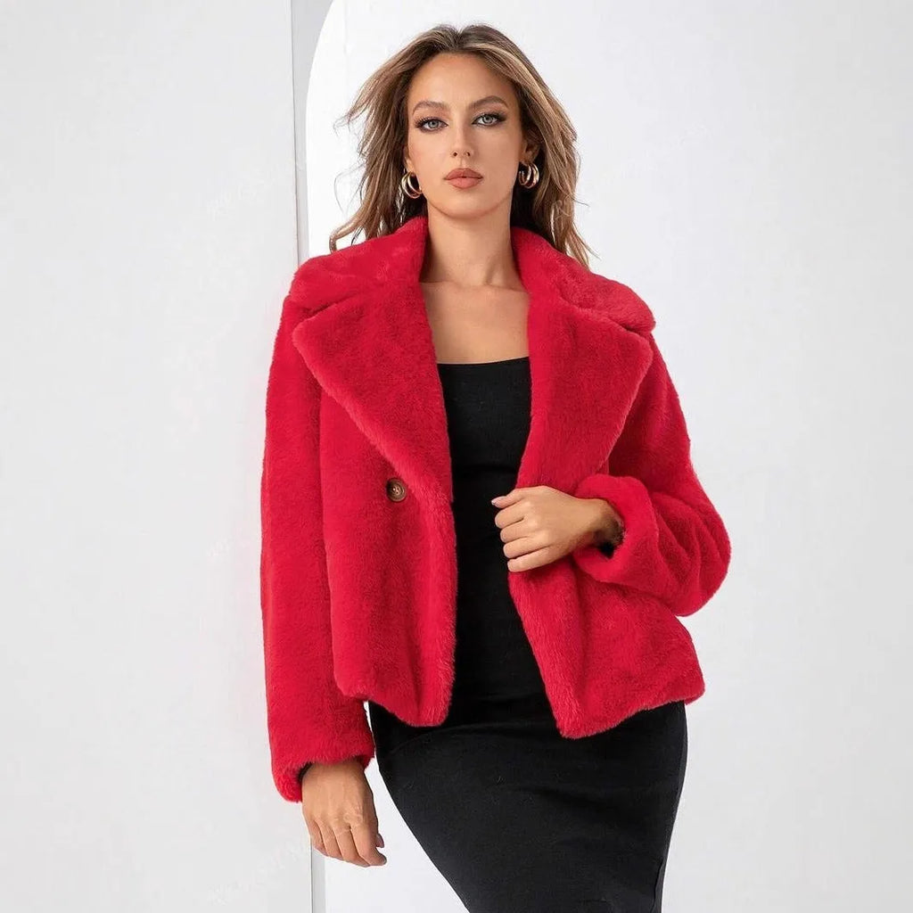 Women's short loose faux fur coat in rose red colour on a hanger.