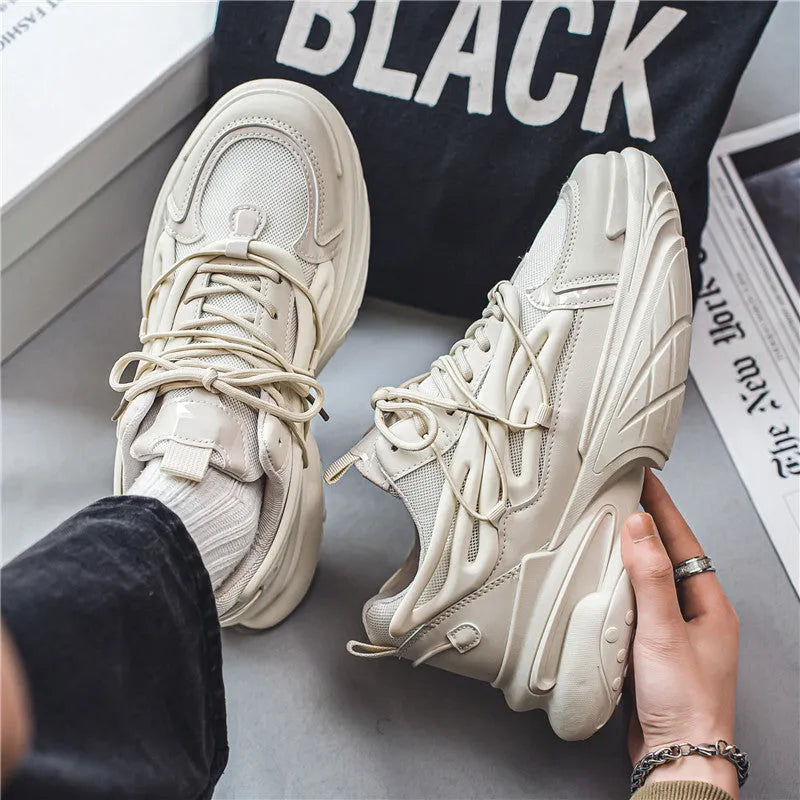 Men's low-top sneakers in beige with mesh upper, rubber sole, and front lace-up design on a white background.